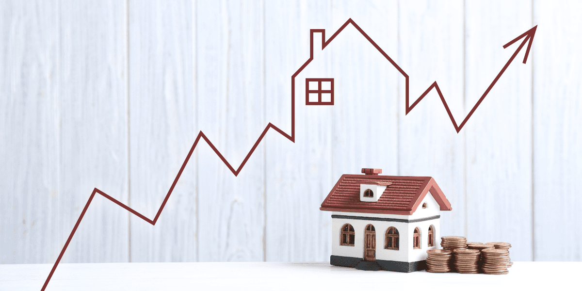 Model house with coins and a rising graph line in the background