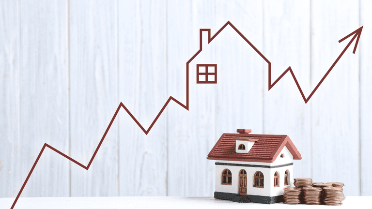 Model house with stacked coins beside a rising home price chart illustration.