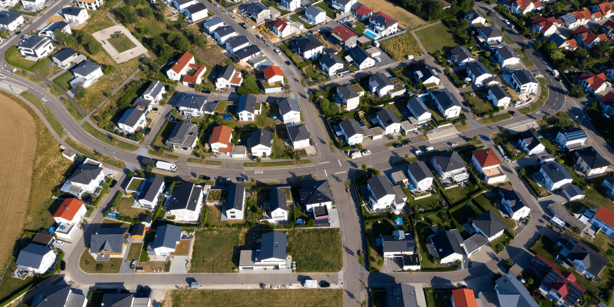Aerial view of a suburban neighborhood with homes, streets, and residential developments.