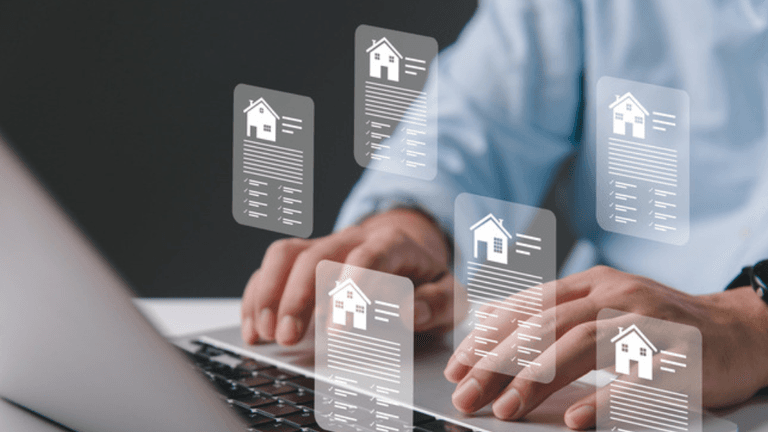 Person typing on a laptop with floating document icons related to real estate.