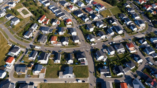 Aerial view of a suburban neighborhood with homes, streets, and residential developments.